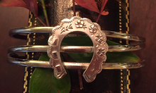 Load image into Gallery viewer, Bracelet, AH designed, a Sterling cuff bracelet is mounted w 19th c Sterling horse shoe brooch
