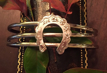 Load image into Gallery viewer, Bracelet, AH designed, a Sterling cuff bracelet is mounted w 19th c Sterling horse shoe brooch
