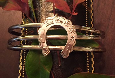 Bracelet, AH designed, a Sterling cuff bracelet is mounted w 19th c Sterling horse shoe brooch